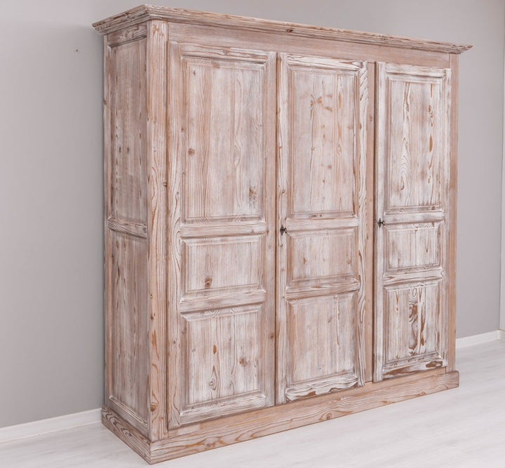 Armoire en pin massif à trois portes, vue de trois quarts