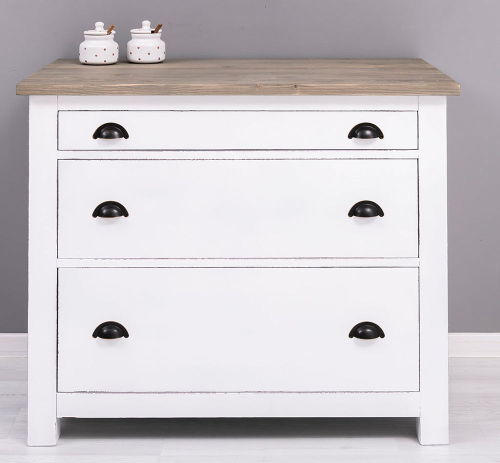 Meuble bas de cuisine en pin massif avec trois tiroirs fermés, vue de face.