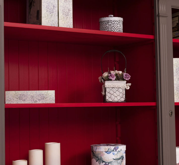 Détail des étagères rouges à l’intérieur d’une bibliothèque style Directoire
